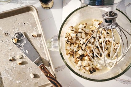 Roasted mini marshmallows added to a stand mixer bowl of whipped cream